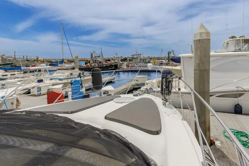 Slide: The Image of 2007 Carver 42 Super Sport yacht docked in a marina under a clear blue sky. - 3