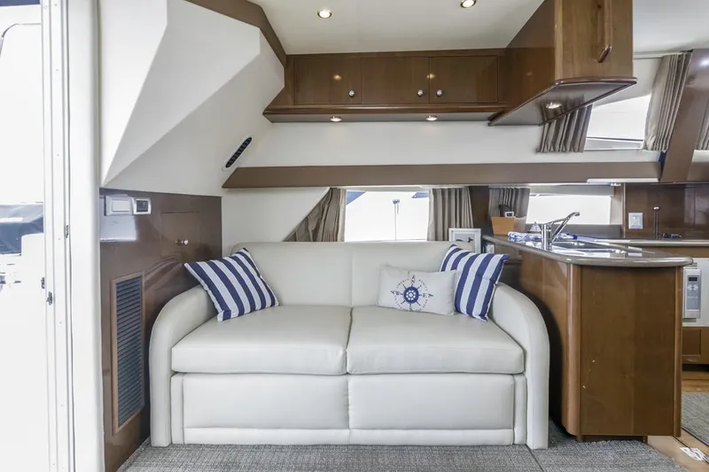 Slide: The Image of Luxurious interior of 2007 Carver 42 Super Sport yacht with white sofa and striped pillows. - 30