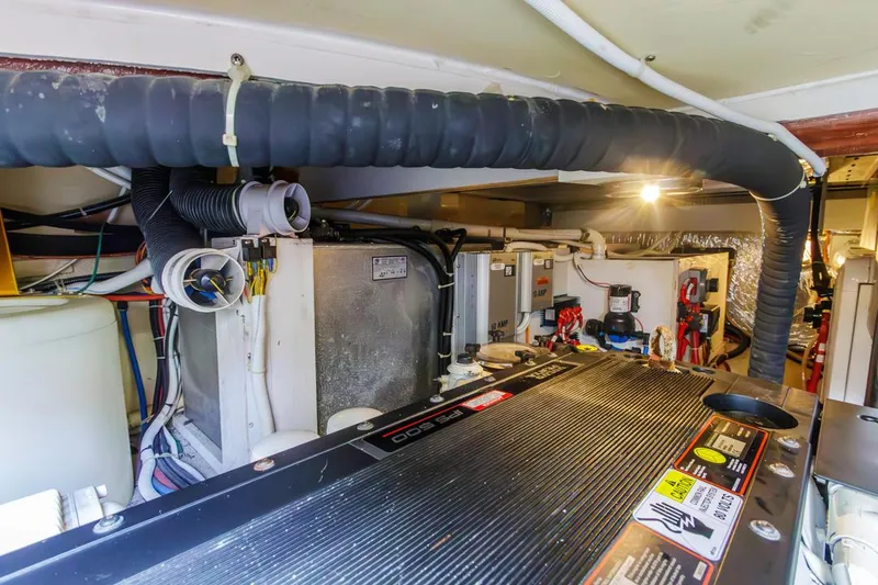 Slide: The Image of Engine room of 2007 Carver 42 Super Sport yacht, showcasing mechanical components and systems. - 34