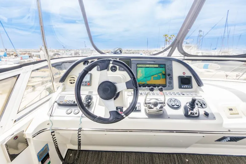 Slide: The Image of 2007 Carver 42 Super Sport yacht helm with navigation controls and steering wheel. - 12