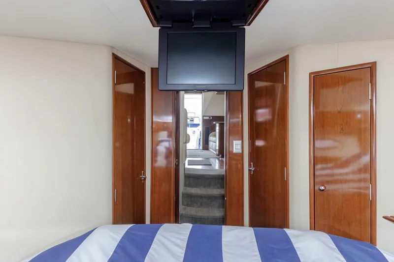 Slide: The Image of Interior of 2007 Carver 42 Super Sport yacht with TV and wooden doors. - 21