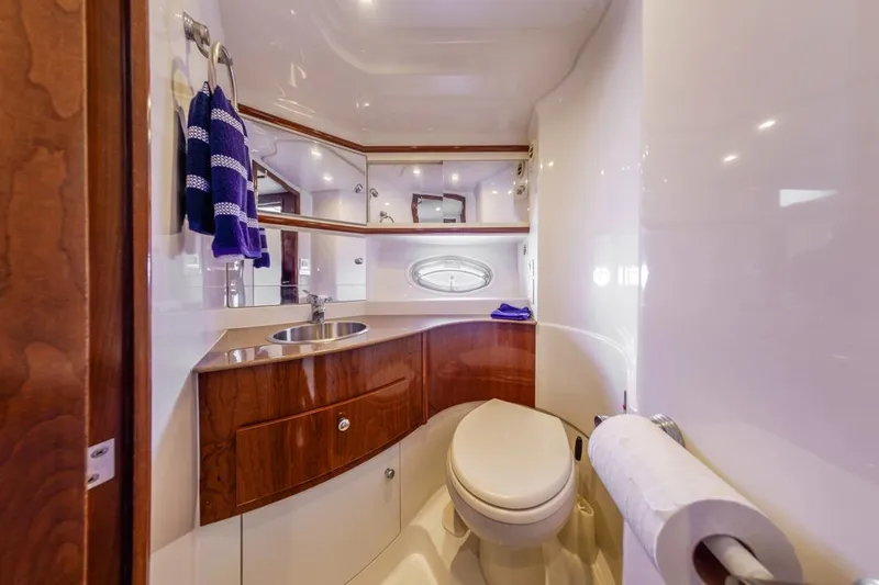 Slide: The Image of Luxurious bathroom in 2007 Carver 42 Super Sport yacht with wood accents and modern fixtures. - 22