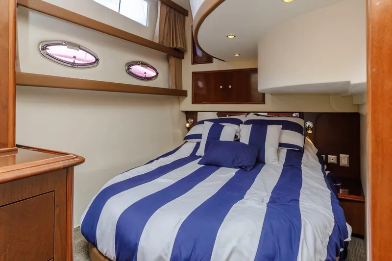 Slide: The Image of Interior of 2007 Carver 42 Super Sport yacht with striped bedding in cozy cabin. - 23