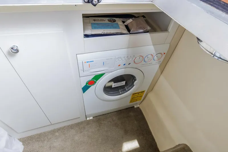 Slide: The Image of Compact washing machine in 2007 Carver 42 Super Sport yacht interior. - 25