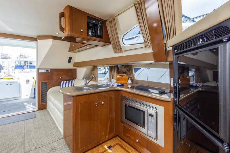 Slide: The Image of Interior of 2007 Carver 42 Super Sport yacht with modern kitchen amenities. - 27