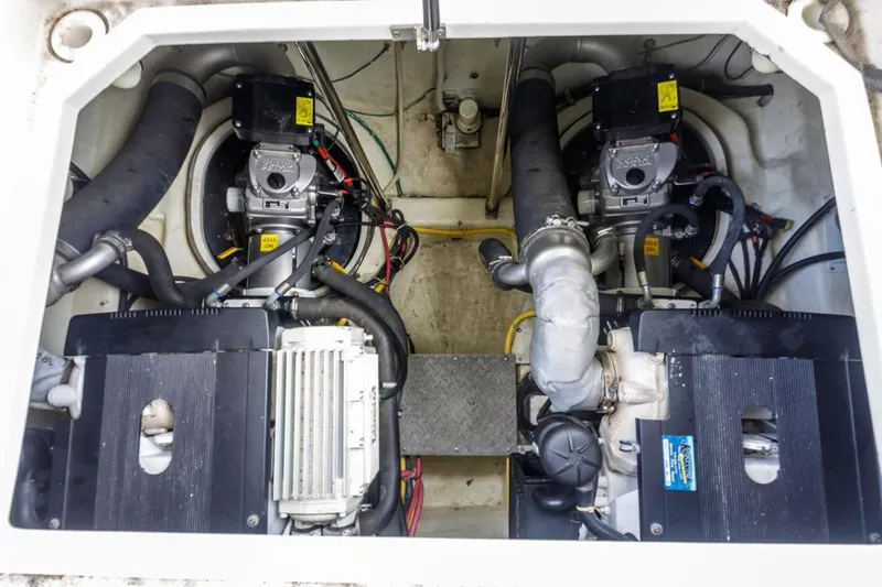 Slide: The Image of Engine compartment of a 2007 Carver 42 Super Sport boat, showcasing dual engines and components. - 31