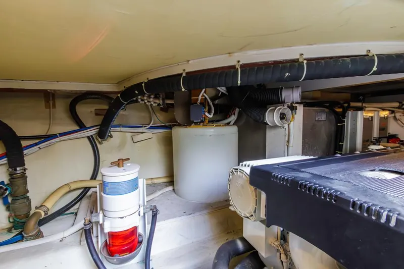 Slide: The Image of Engine room of 2007 Carver 42 Super Sport yacht, showcasing mechanical components and wiring. - 33