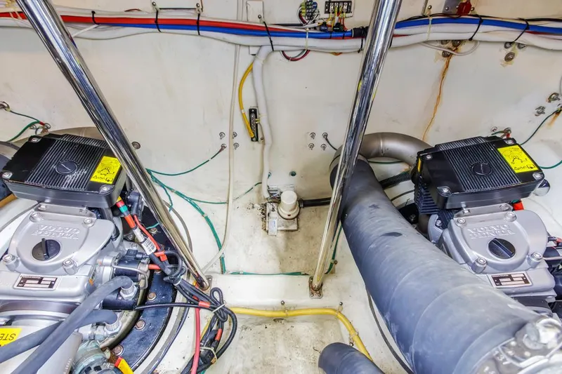 Slide: The Image of Engine room of 2007 Carver 42 Super Sport yacht, showcasing dual engines and wiring. - 36