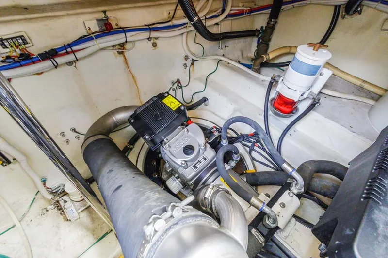 Slide: The Image of Engine room of 2007 Carver 42 Super Sport yacht, featuring mechanical components and wiring. - 37