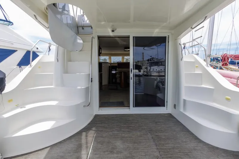 Slide: The Image of 2007 Carver 42 Super Sport yacht with elegant dual staircases and sliding glass doors. - 7