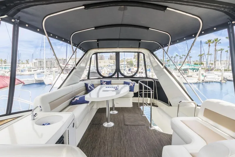 Slide: The Image of 2007 Carver 42 Super Sport yacht interior with seating and marina view. - 8