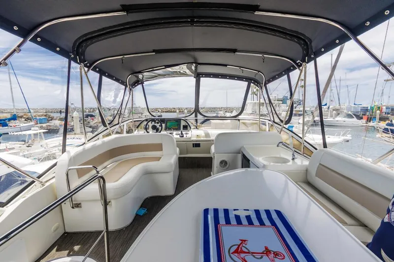 Slide: The Image of 2007 Carver 42 Super Sport yacht interior with seating and helm, docked at marina. - 9