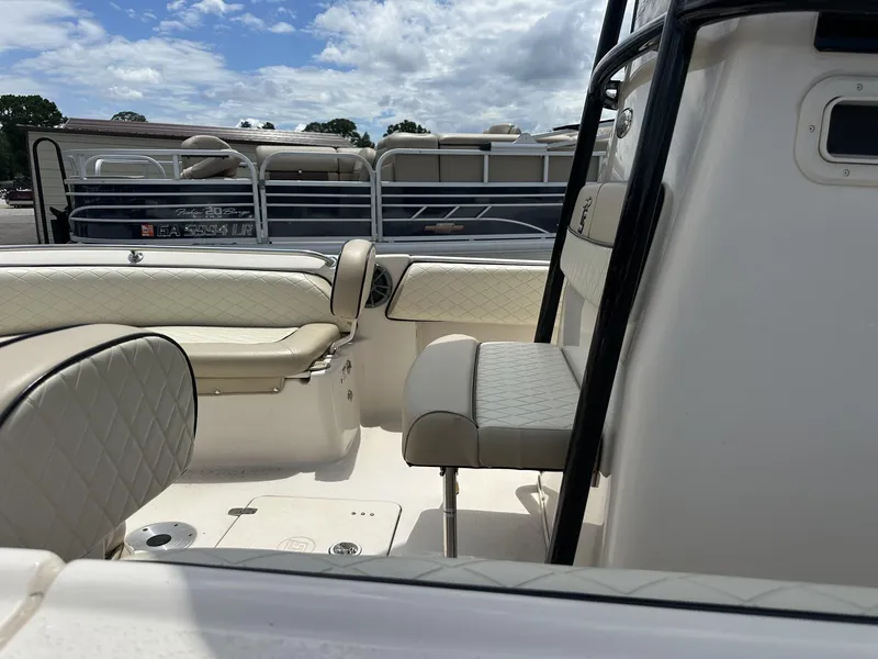 Slide: The Image of 2023 Carolina Skiff 23 Ultra Elite boat interior with cushioned seating and console. - 5
