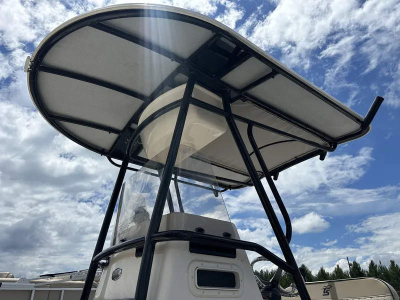 Slide: The Image of 2023 Carolina Skiff 23 Ultra Elite boat with T-top against a cloudy sky. - 7