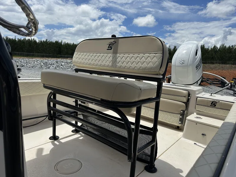 Slide: The Image of 2023 Carolina Skiff 23 Ultra Elite boat interior with seating and Suzuki outboard motor. - 8