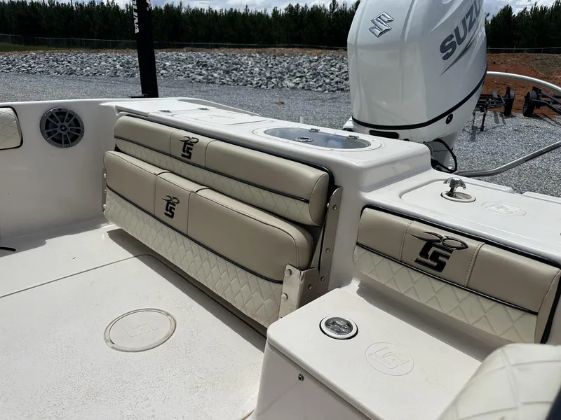 Slide: The Image of 2023 Carolina Skiff 23 Ultra Elite boat interior with Suzuki engine and cushioned seating. - 9