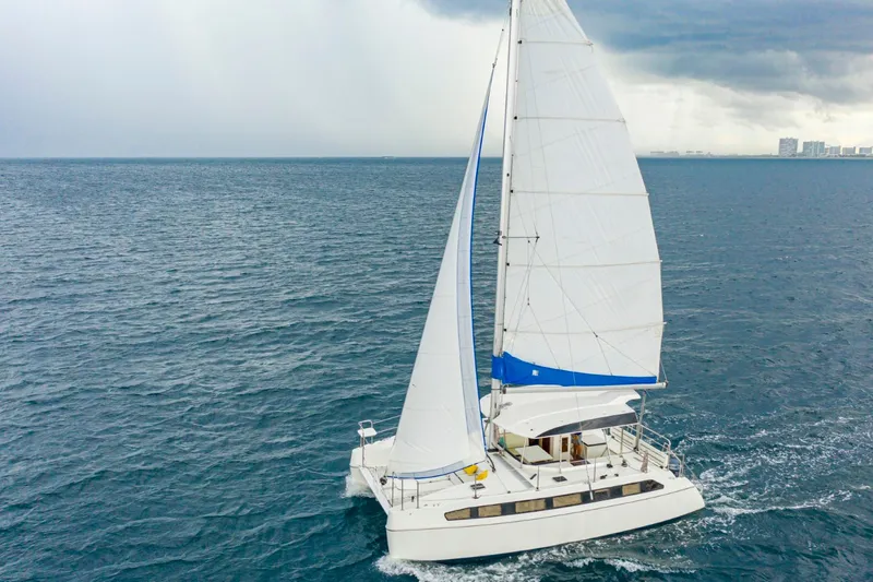 Slide: The Image of Sailing catamaran Smart Cat S280, 2025 model, cruising on open sea under cloudy skies. - 1