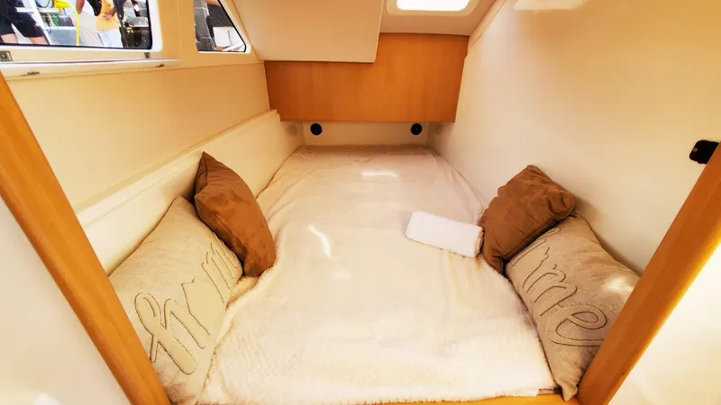 Slide: The Image of Cozy cabin interior of 2025 Smart Cat S280 with plush bedding and pillows. - 31