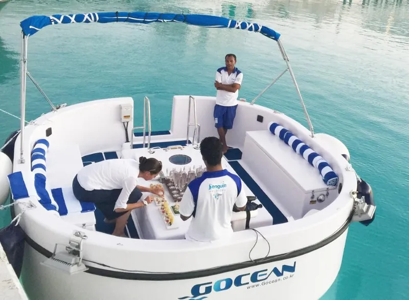 Slide: The Image of 2023 Penguin Semi-Submarine 2.0 Electric with crew on turquoise water. - 11