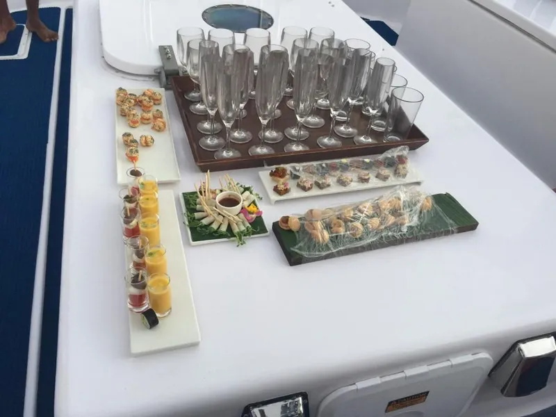 Slide: The Image of Luxurious spread of appetizers and champagne glasses on a 2023 Penguin Semi-Submarine 2.0 Electric. - 12
