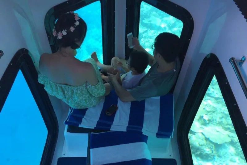 Slide: The Image of Family enjoying underwater views in a 2023 Penguin Semi-Submarine 2.0 Electric. - 20