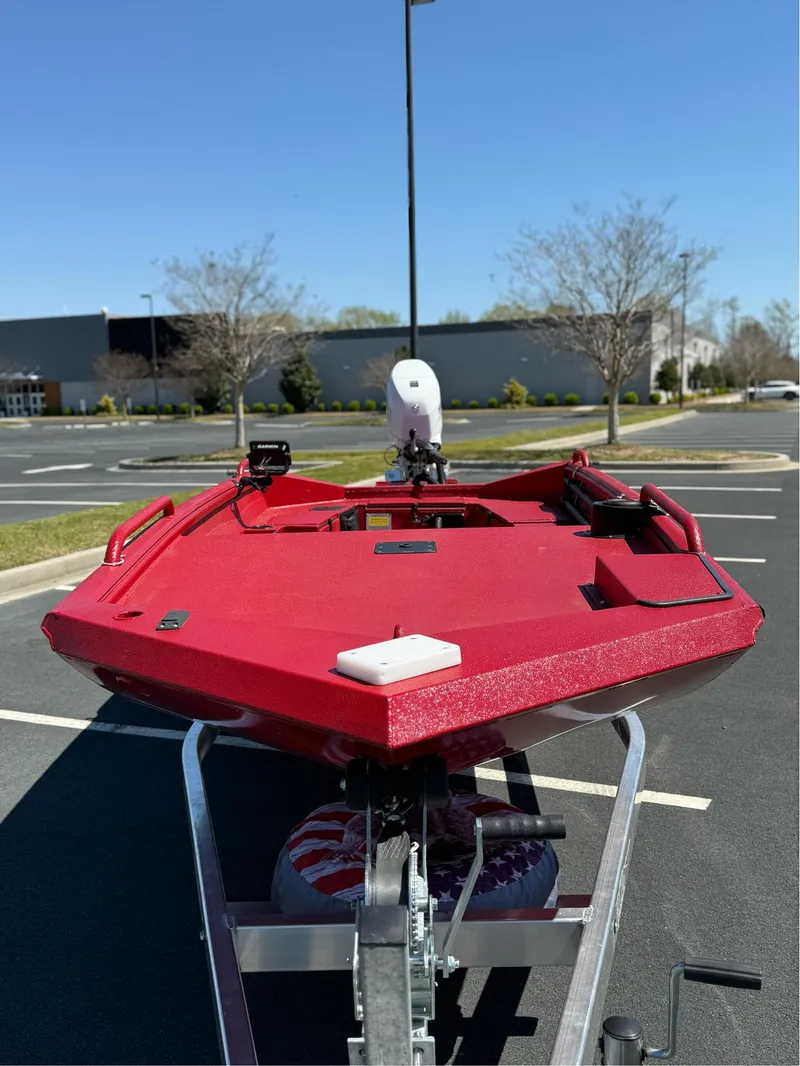 Slide: The Image of Red 2024 Excel 1751 V4 boat on trailer in parking lot, clear sky background. - 10