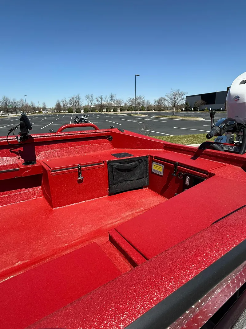Slide: The Image of Red 2024 Excel 1751 V4 boat interior in a parking lot under clear blue sky. - 16