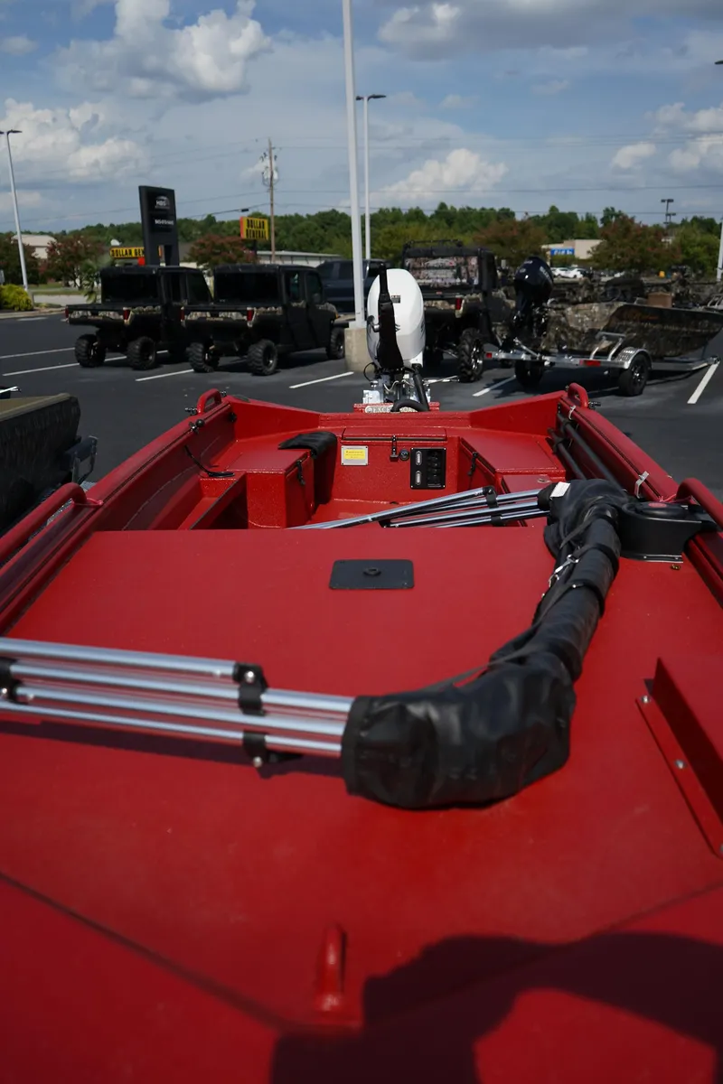 Slide: The Image of Red Excel 1751 V4 boat, 2024 model, parked outdoors with clear sky background. - 18