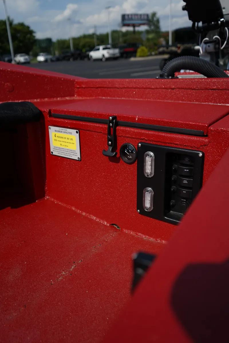 Slide: The Image of Red interior of 2024 Excel 1751 V4 boat with control panel and warning label. - 19