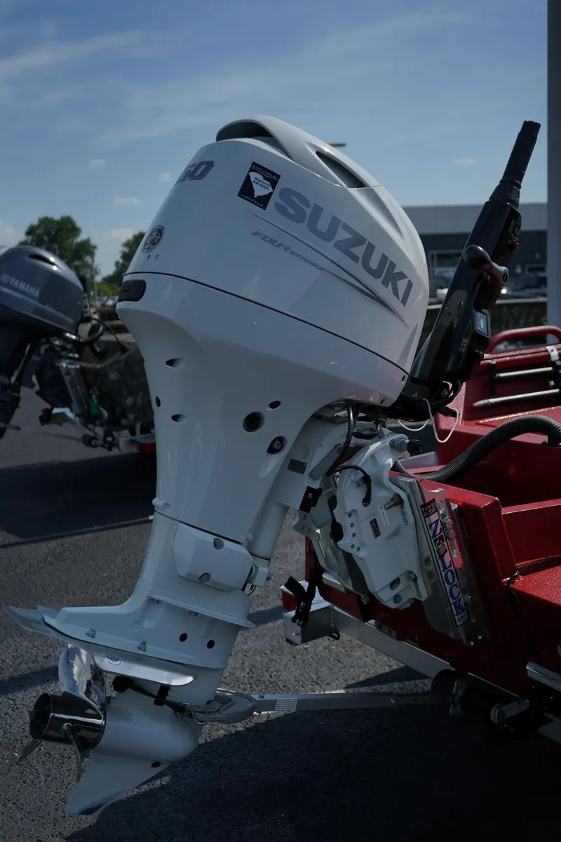Slide: The Image of Outboard motor on a red boat trailer, featuring Suzuki branding, under a clear blue sky. - 21