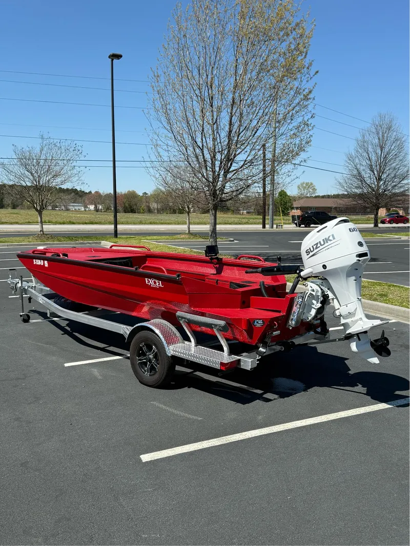 Slide: The Image of Red 2024 Excel 1751 V4 boat with Suzuki engine on a trailer in a parking lot. - 3