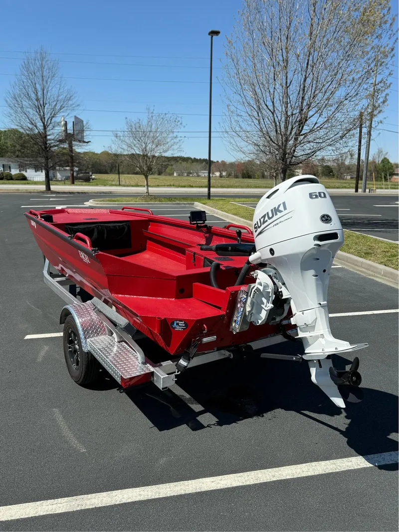 Slide: The Image of Red 2024 Excel 1751 V4 boat with Suzuki 60 outboard motor on trailer. - 4
