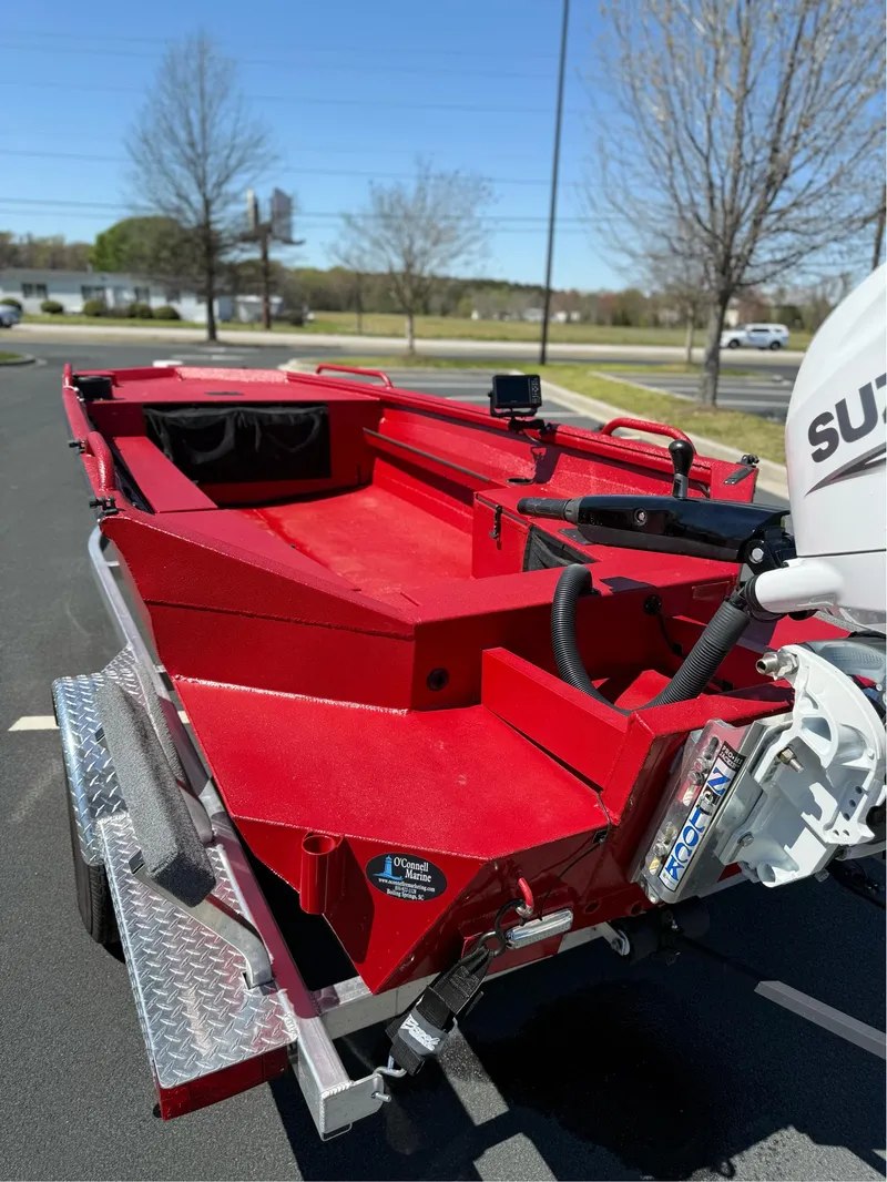 Slide: The Image of Red 2024 Excel 1751 V4 boat on trailer, parked outdoors, with visible motor. - 5
