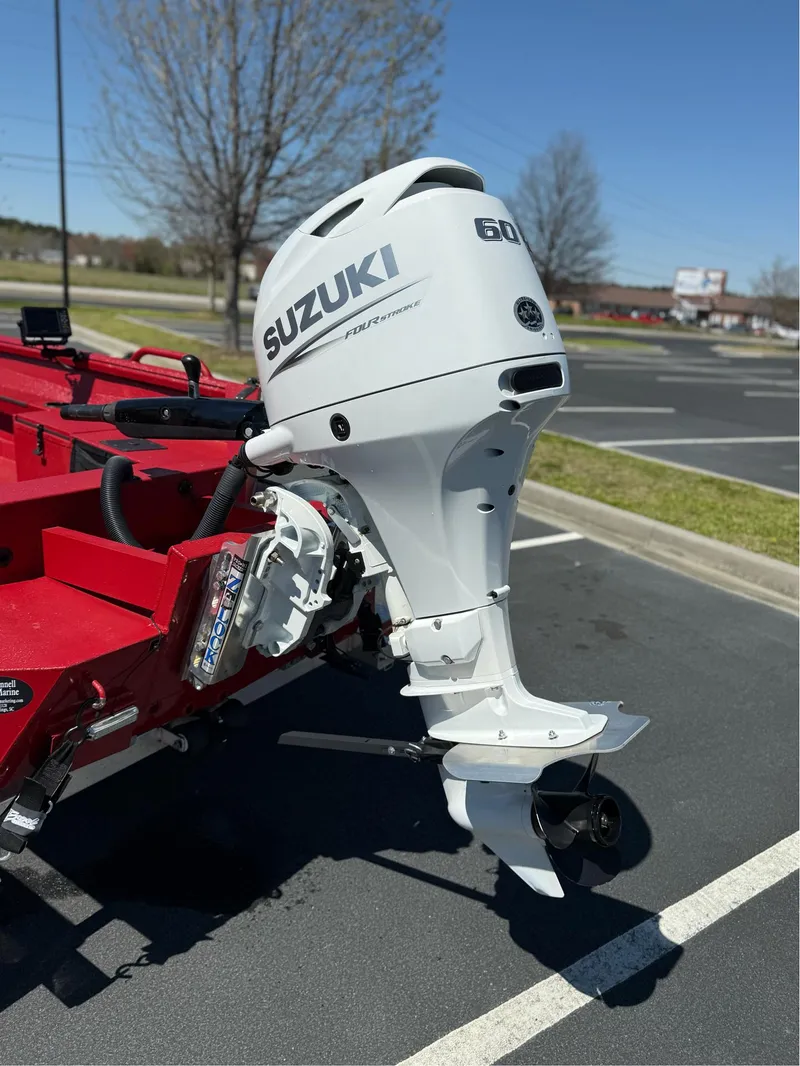 Slide: The Image of 2024 Excel 1751 V4 boat with Suzuki 60 horsepower outboard motor in parking lot. - 6