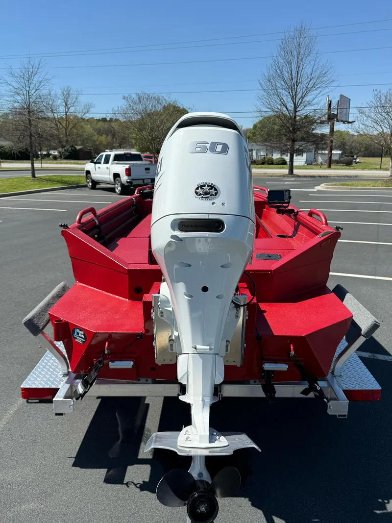 Slide: The Image of Red 2024 Excel 1751 V4 boat with a 60 HP outboard motor in a parking lot. - 8