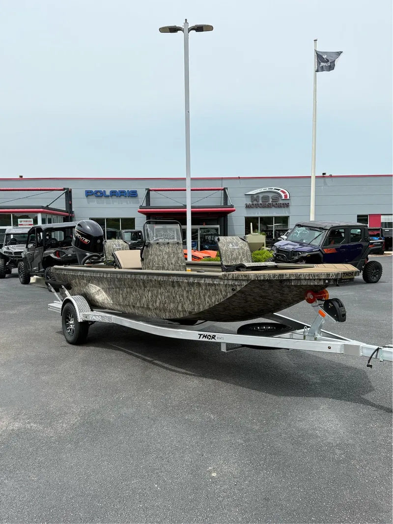 Slide: The Image of 2025 Thor Lake Hammer 1900CC boat on trailer at dealership. - 1