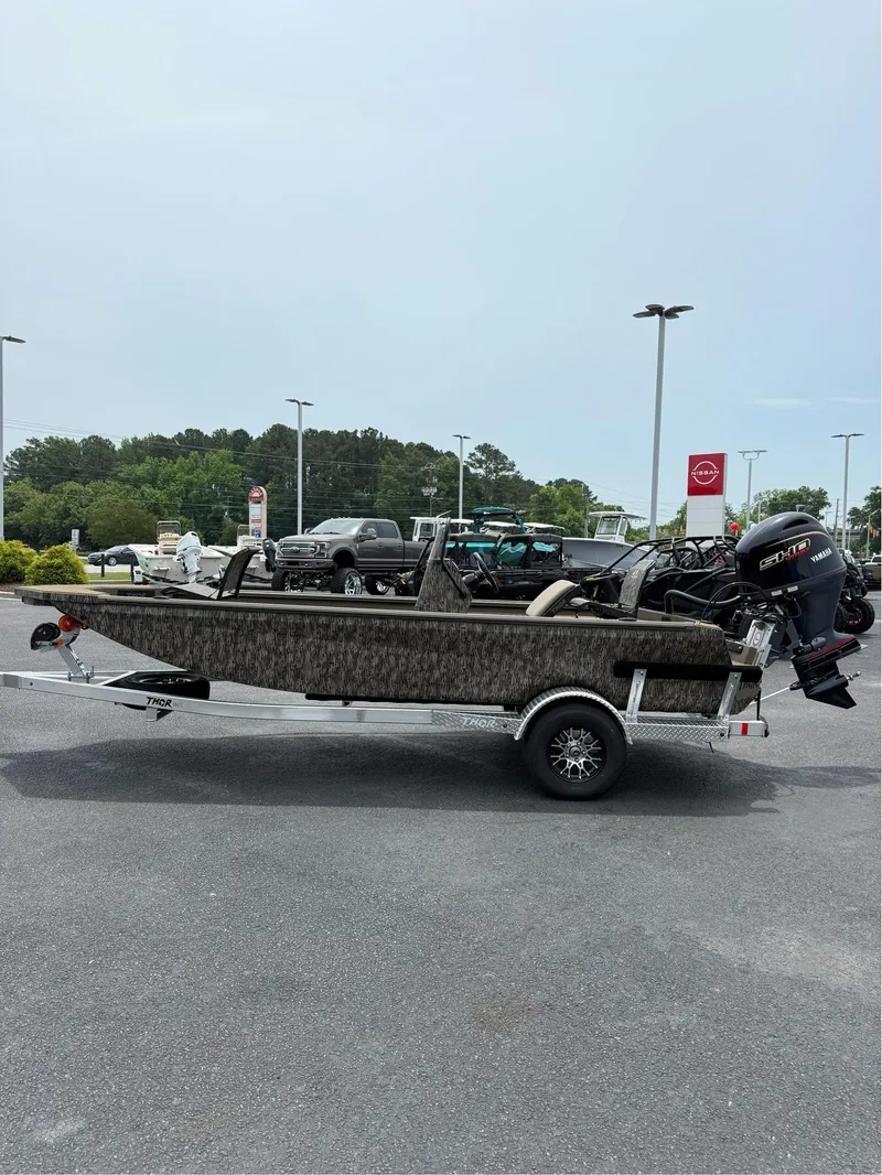 Slide: The Image of 2025 Thor Lake Hammer 1900CC boat on trailer in parking lot. - 10