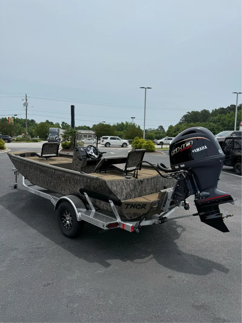 Slide: The Image of 2025 Thor Lake Hammer 1900CC boat on trailer with Yamaha engine in parking lot. - 11
