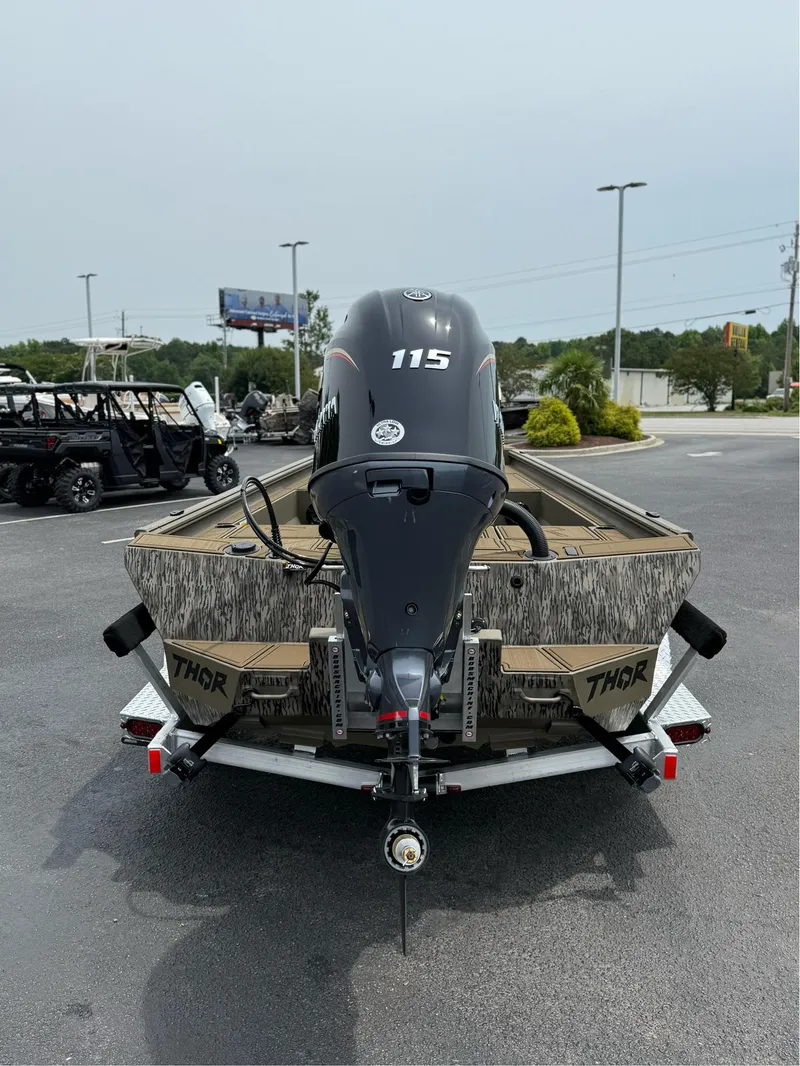 Slide: The Image of 2025 Thor Lake Hammer 1900CC boat with 115 horsepower engine, parked outdoors. - 12