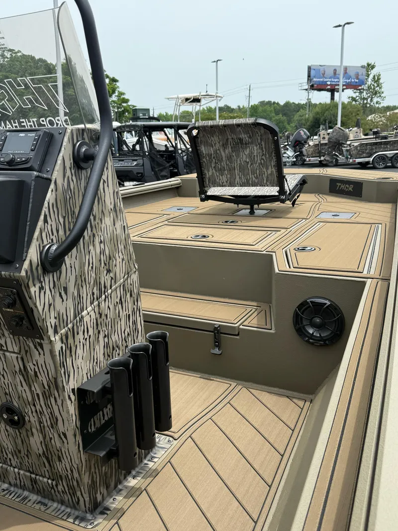Slide: The Image of 2025 Thor Lake Hammer 1900CC boat interior with camouflage design and seating. - 15