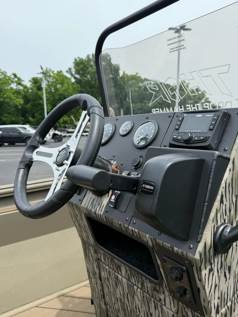 Slide: The Image of 2025 Thor Lake Hammer 1900CC boat dashboard with steering wheel and controls. - 20