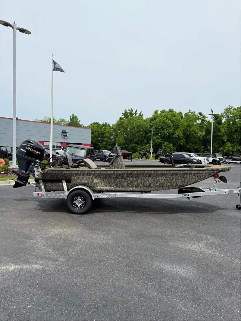 Slide: The Image of 2025 Thor Lake Hammer 1900CC boat on trailer in parking lot. - 3