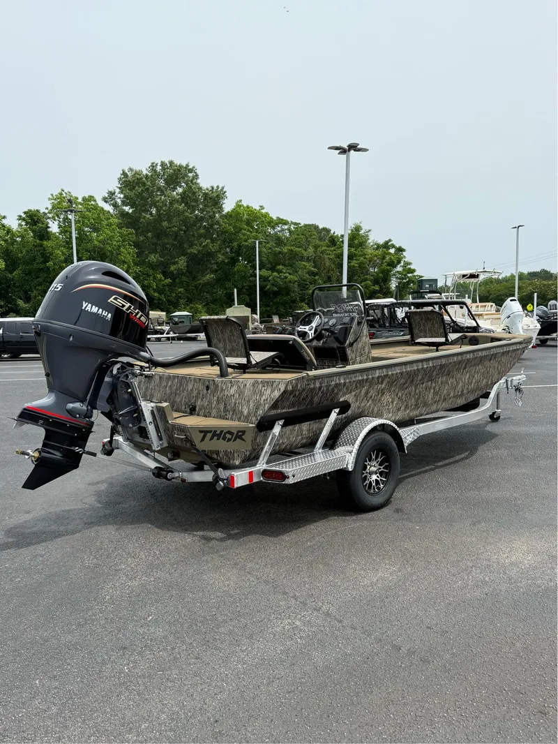 Slide: The Image of 2025 Thor Lake Hammer 1900CC boat on trailer with Yamaha engine, parked outdoors. - 4