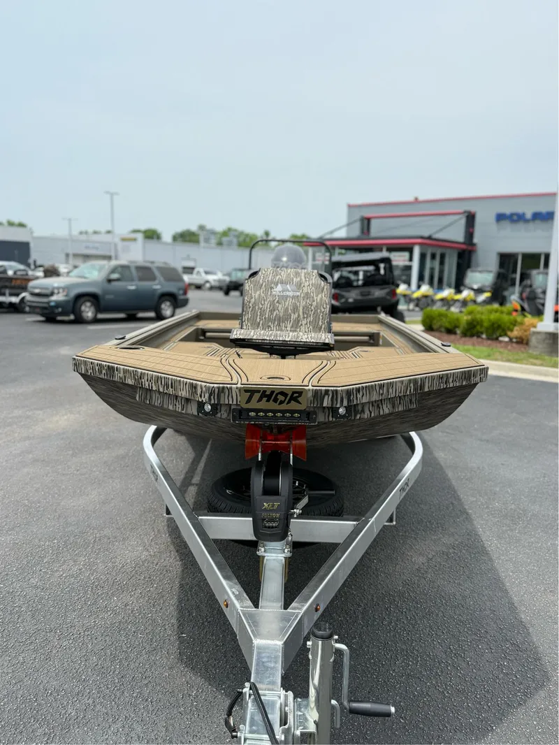 Slide: The Image of 2025 Thor Lake Hammer 1900CC boat on trailer at dealership. - 5