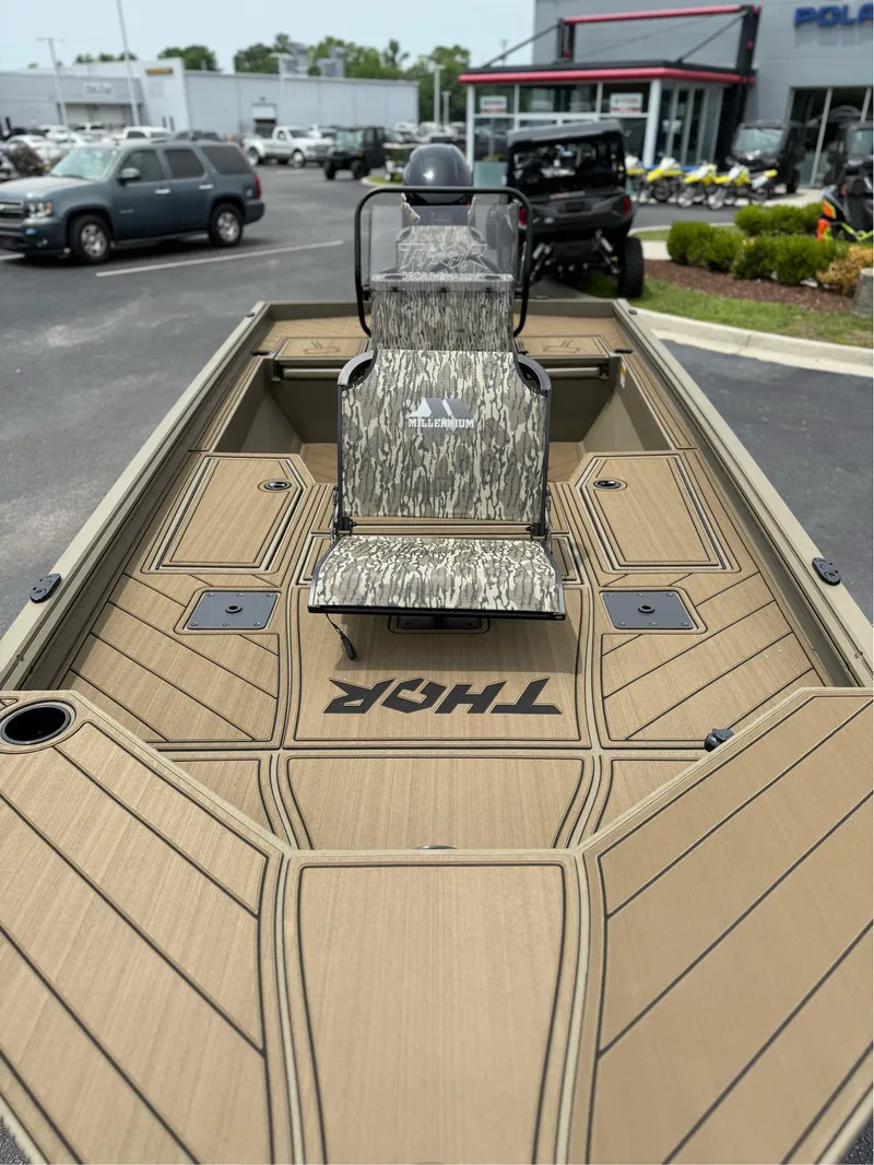 Slide: The Image of 2025 Thor Lake Hammer 1900CC boat with camo seat, displayed at dealership. - 6