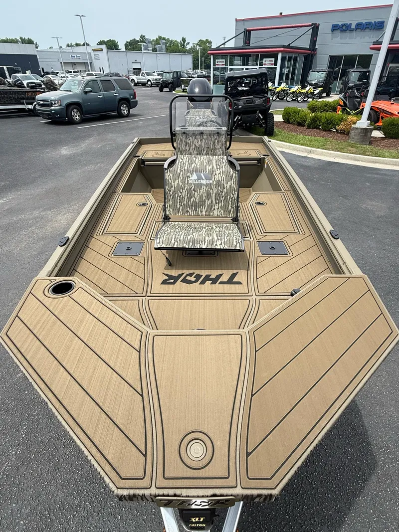 Slide: The Image of 2025 Thor Lake Hammer 1900CC boat with camo seat, displayed at dealership. - 7