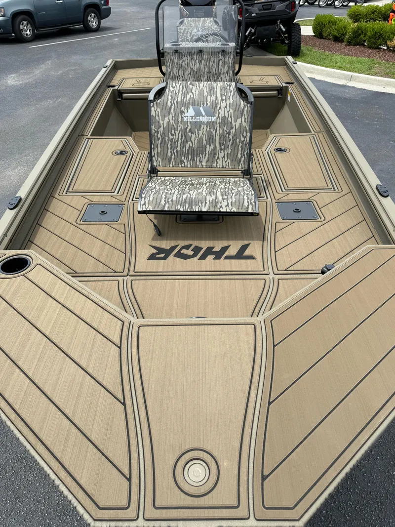 Slide: The Image of 2025 Thor Lake Hammer 1900CC boat with camo seat and tan deck. - 8