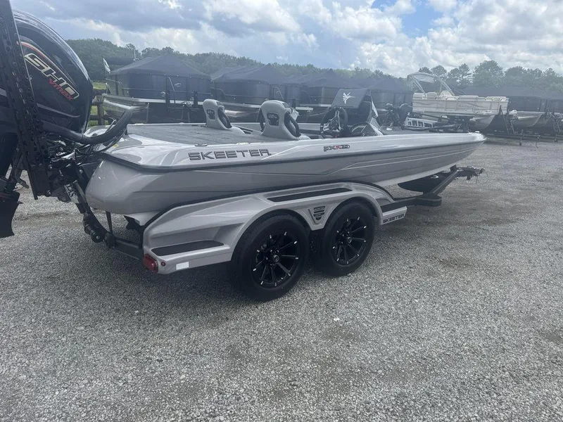 Slide: The Image of 2025 Skeeter FXR20L boat on trailer, parked outdoors under cloudy sky. - 3