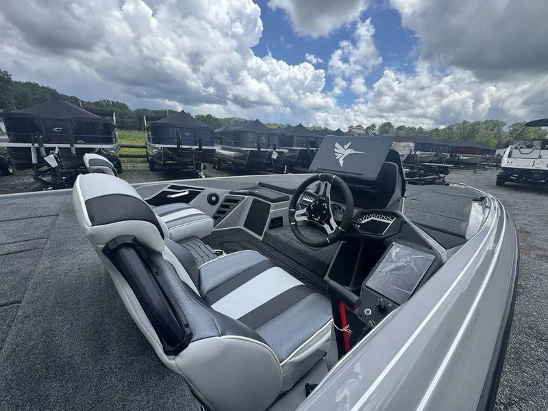Slide: The Image of 2025 Skeeter FXR20L boat interior with modern steering and seating, under a cloudy sky. - 4