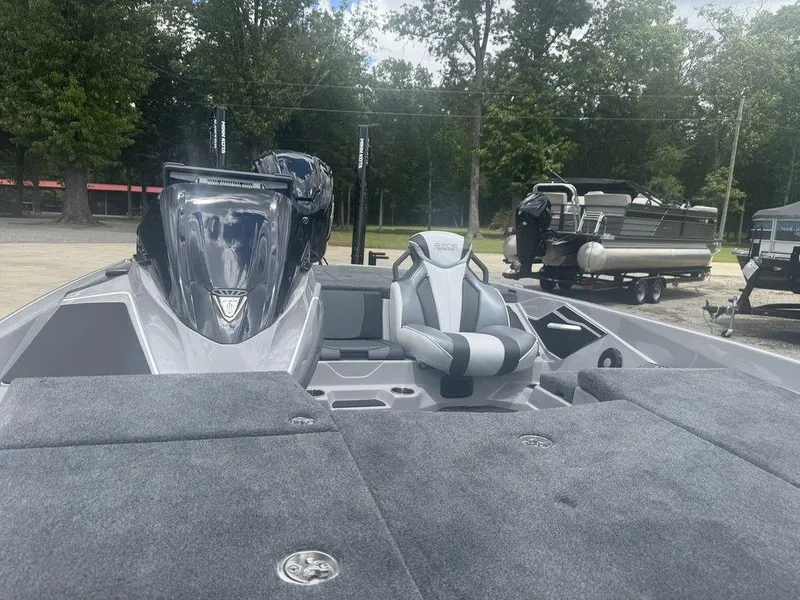 Slide: The Image of 2025 Skeeter FXR20L boat with sleek design and comfortable seating, parked outdoors. - 7